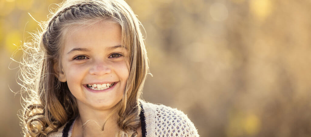 Beautiful Portrait of smiling little girl outdoors.