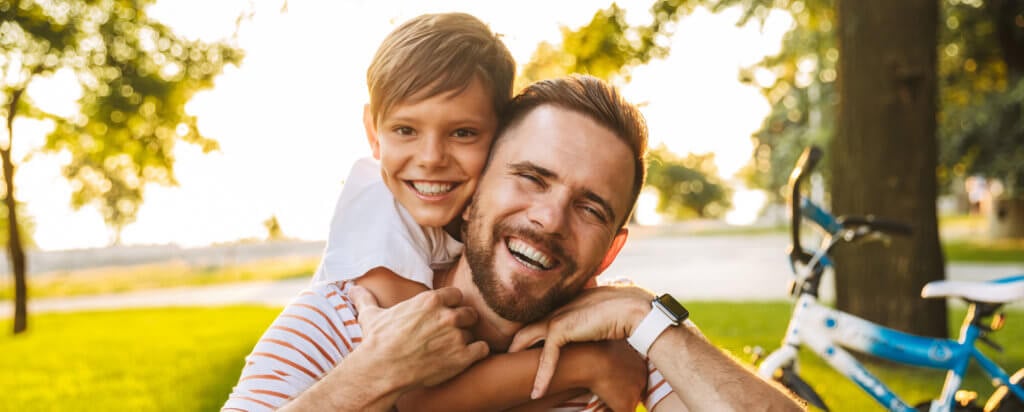 Laughing father and his son having fun together