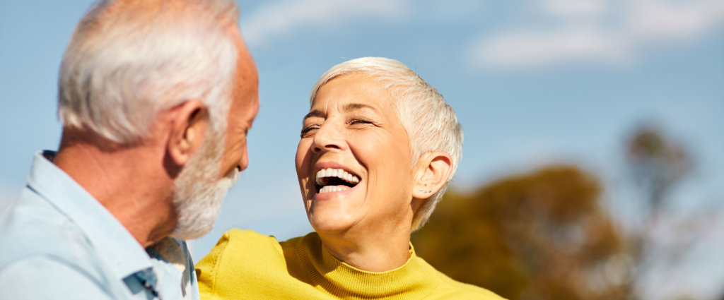 mature loving couple smiling at one another